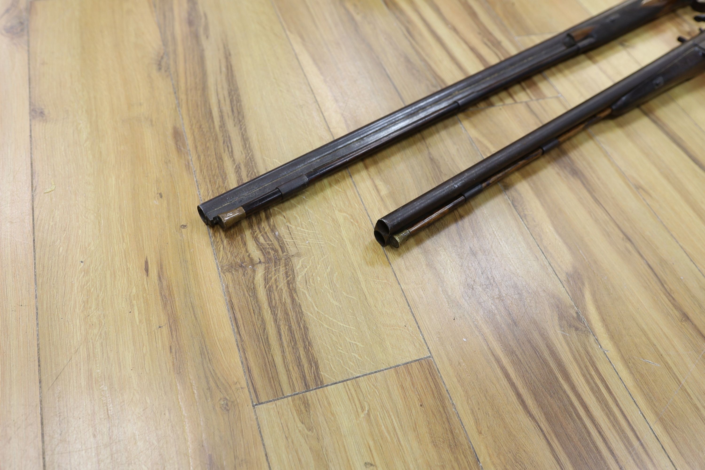 Two 19th century percussion muskets, 103cm. max., one double-barrelled